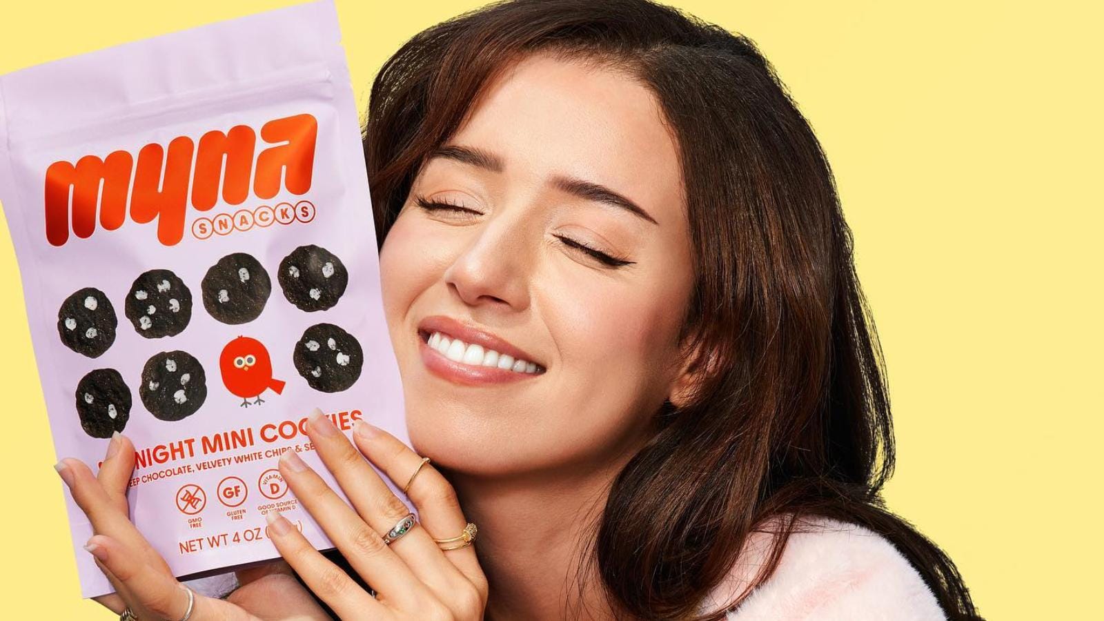 Pokimane holding a bag of Myna Snacks cookies
