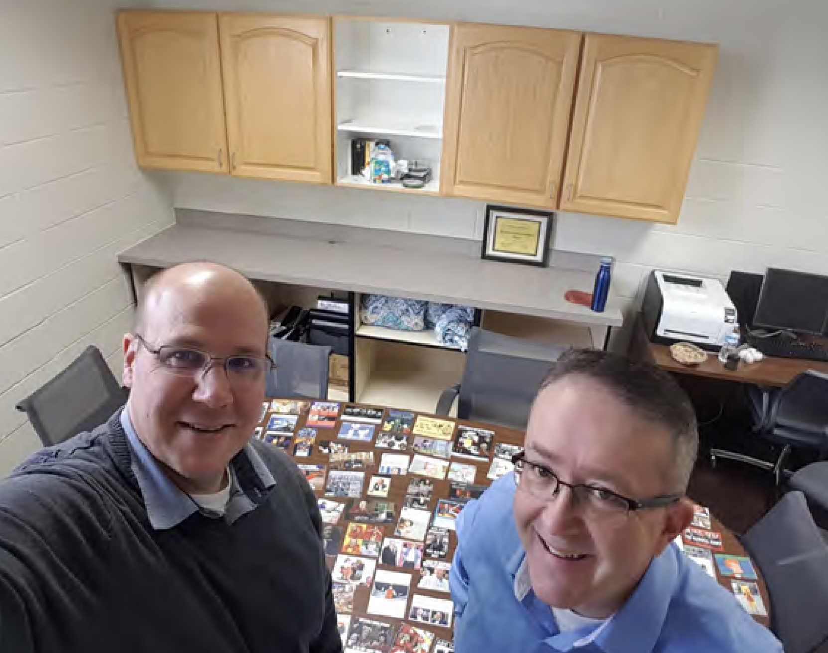 Photo of Professor Stein and Professor Barton standing in front of a table with memes spread out for coding